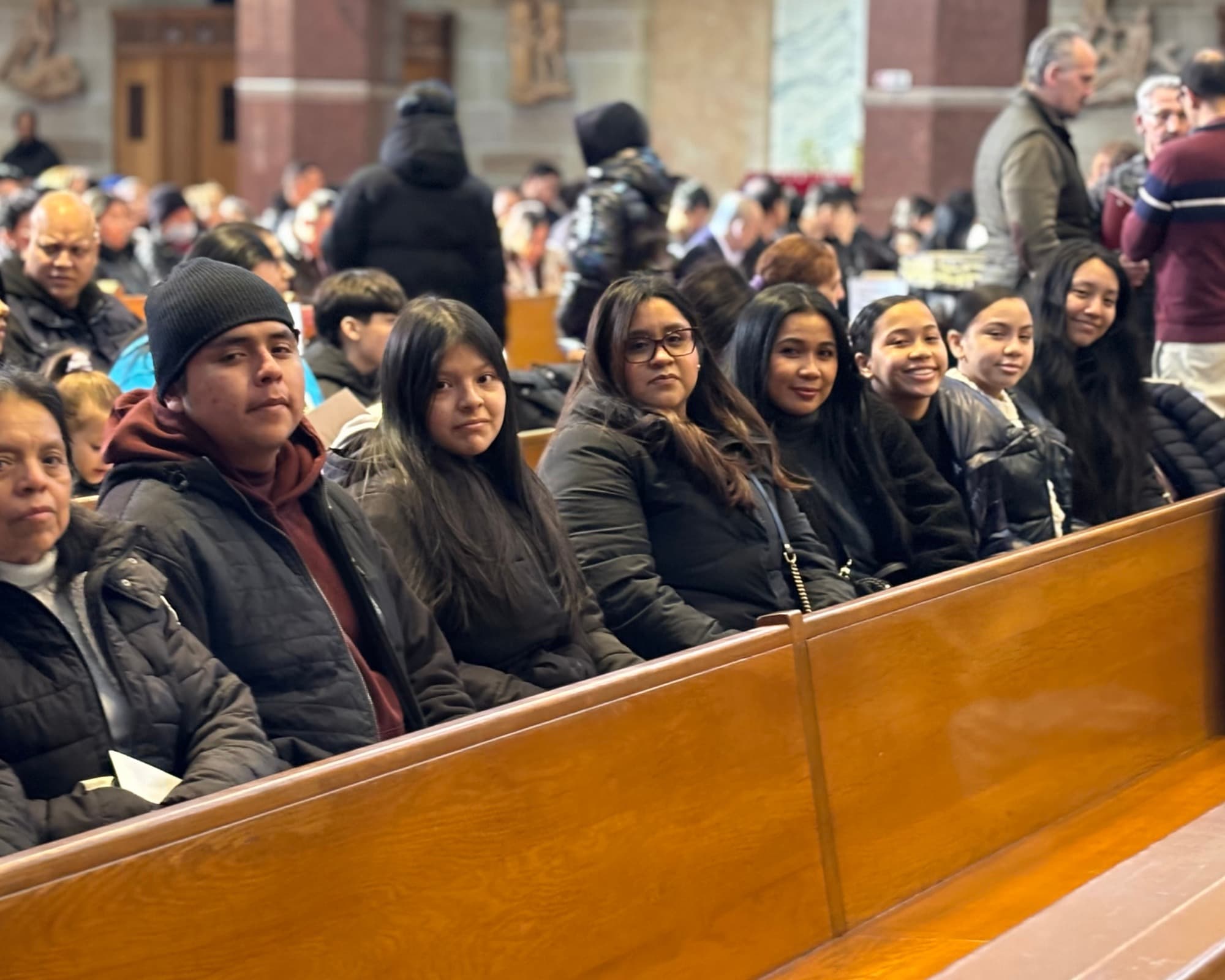 Volunteers gathered near the parish courtyard statue